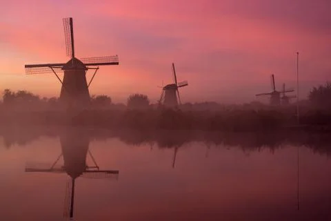 Windmills at sunset Stock Photos