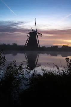 Windmills at sunset Stock Photos