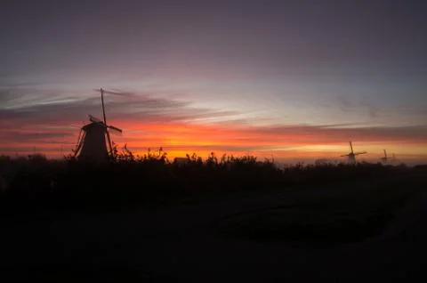 Windmills at sunset Stock Photos