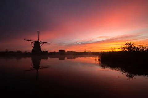 Windmills at sunset Stock Photos