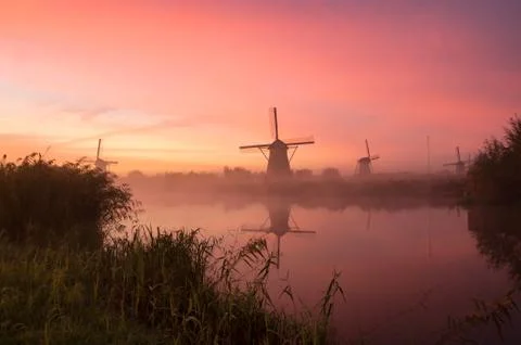 Windmills at sunset Stock Photos