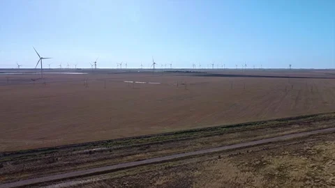 Windmills of a wind farm generating electricity in a field rotating slowly... Stock Footage 252397640
