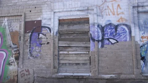 The Window Of An Abandoned Building Is Boarded Up. Graffiti on the Walls. Kazan. Stock Footage 195934871