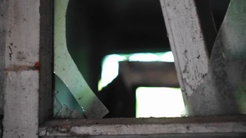 The window of an abandoned house is broken and the glass is broken Stock Footage 307224554