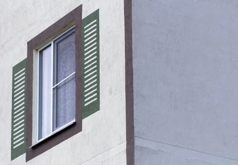 Window against the background wall of a multistory building. Stock Photos