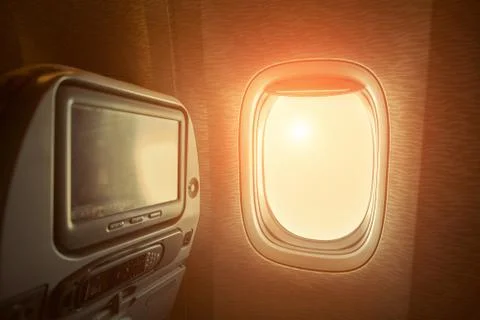 Window in airplane with sunlight. Stock Photos