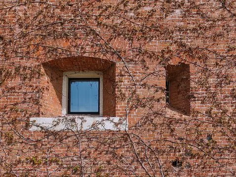 Window in an ancient brick house Stock Photos