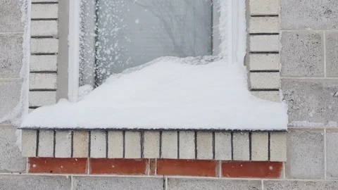 Window and windowsill covered with snow, small snowdrift on sill Vídeo Stock 169078250