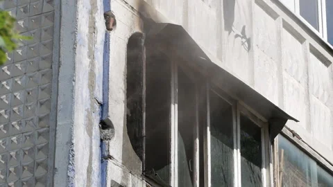 Window of an apartment building from which smoke comes out. Side view. Fire Stock Footage 145914746