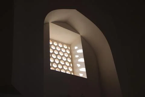 Window with arc shaped frame in dark room Foto stock