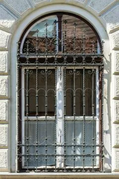 Window with arch and bars. Stock Photos