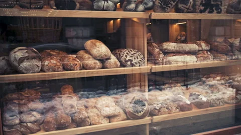 Window in bakery with fresh bread in early morning, pan shot. Stock Footage 86047353