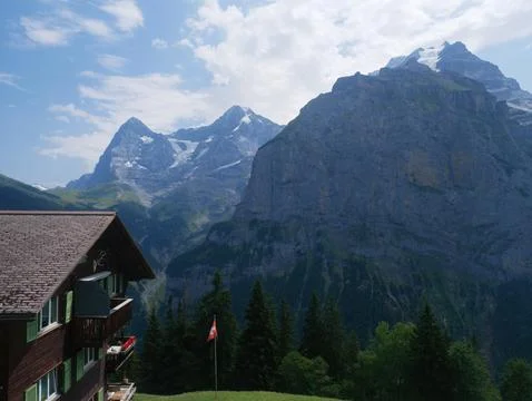 Window balcony view mountain peaks alpine house Switzerland summer travel Stock Photos