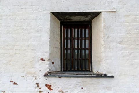 Window with bars in an old medieval castle. Stock Photos