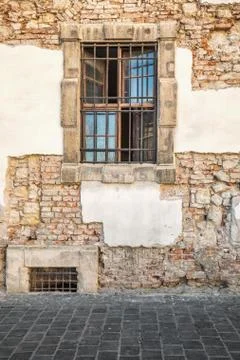 Window with bars on old wall Stock Photos