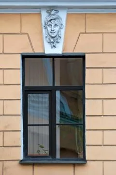 A window with a bas-relief. Stock Photos