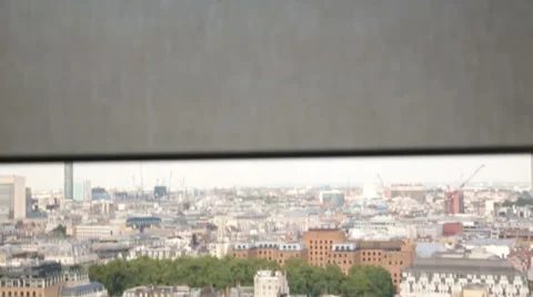Window blind opens onto London view 動画素材 35091165