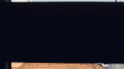 Window blind slowly rolling up revealing the view of buildings in the city. Stock Footage 128111935