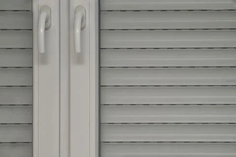 Window blinds and close-up, double-leaf white plastic window, two window handles Stockfoto's