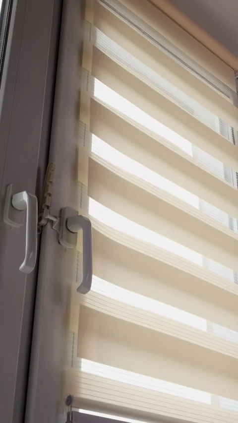 Window blinds move gently in the light as they open and close at a house during 库存影片 324143833
