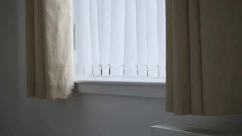 Window blinds moving in wind Stock Footage 135202979
