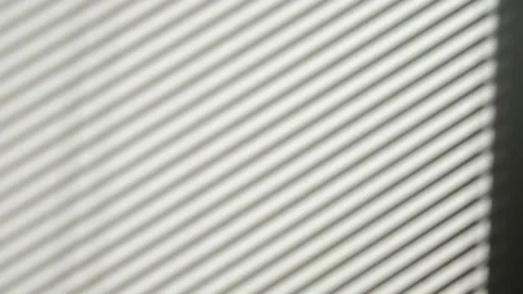 Window blinds shadow opening and closing on white wall surface background 库存影片 347122755