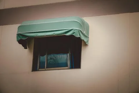 A window with a blue awning over it Stock-Fotos