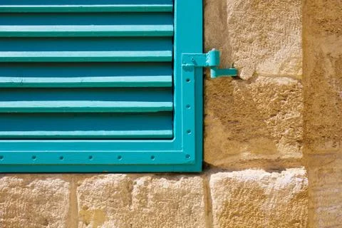 Window blue closed shutters on a stone wall. Close up. Foto stock
