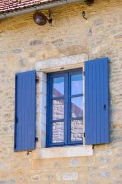 Window with blue shutters Fotos de archivo
