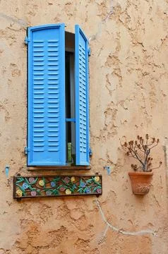 A window with blue shutters Stock Photos