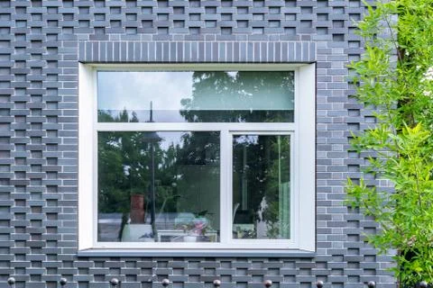 Window on the blue wall. Stock Photos