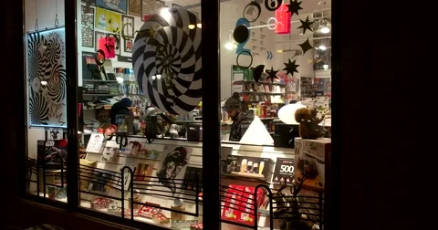 The window of a bookstore glows in the night Stock Footage 67732044