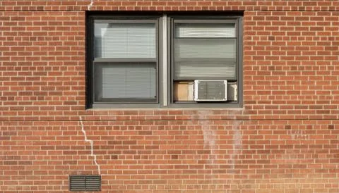 Window on brick red wall whith AC Stock Photos