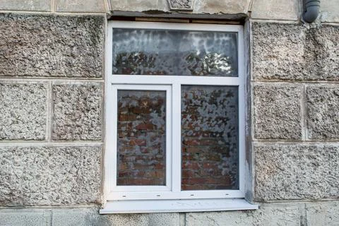 Window with a brick wall behind it. Suicide prevention concept Stock Photos