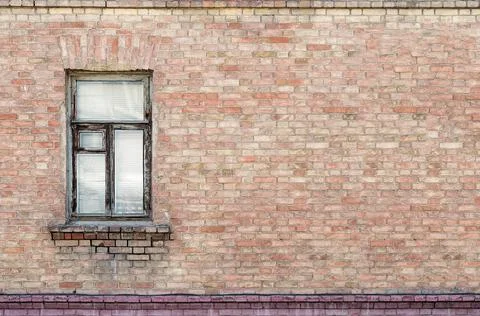 Window in a brick wall. Fragment of the facade Stock Photos
