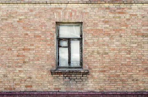 Window in the brick wall of an old building Fotos de archivo