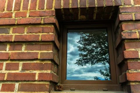 A window in a brick wall Stock Photos