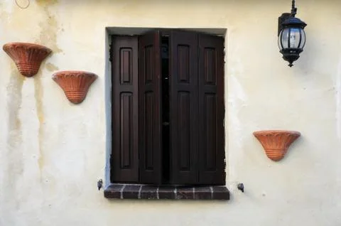 Window with brown shutters Stock Photos