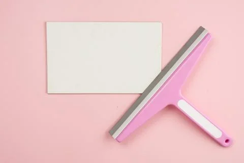 Window brush lying on empty white mockup on pink background. Concept cleaning Stock Photos