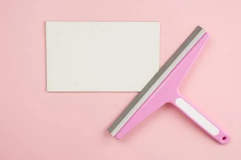 Window brush lying on empty white mockup on pink background. Concept cleani.. Stock Photos