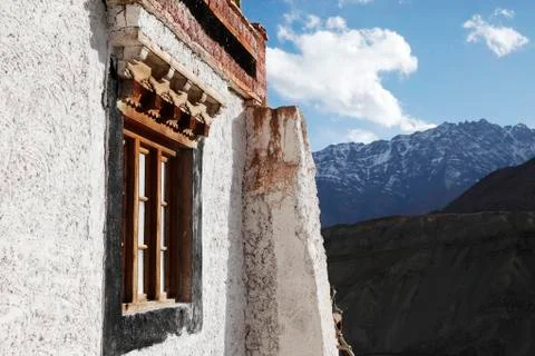Window of Buddhist monastery surrounded by mountains. Stock Photos