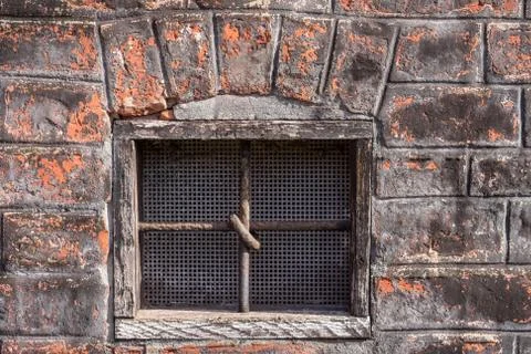 Window in the building with cross bars Stock Photos