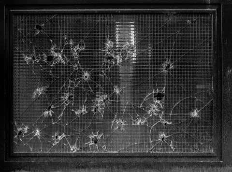 Window with bullet marks all over Foto stock