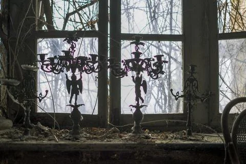 Window with candlesticks in abandoned house Stock Photos