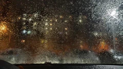 A window of a car is covered in rain and the view of the city is blurred Stock Footage 276065277