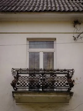 A window with a carved balcony in an old German-built apartment building Stock Photos