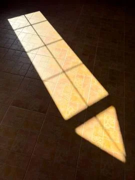A window casts a shadow on the floor, creating a triangular shape 스톡 사진