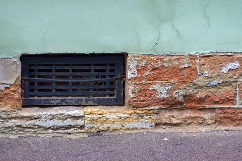 Window of the cellar of the old house Stock Photos
