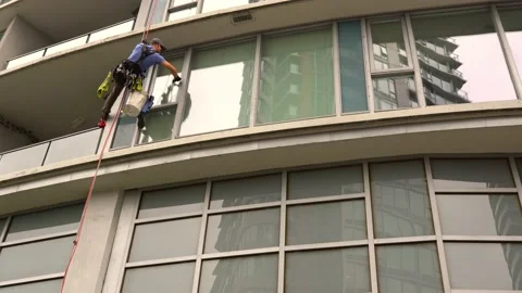 Window Cleaner On Building With Tower In Reflection Stock Footage 197487795