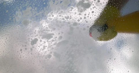 Window cleaner cleans window with foam and puller Stock Footage 190919802